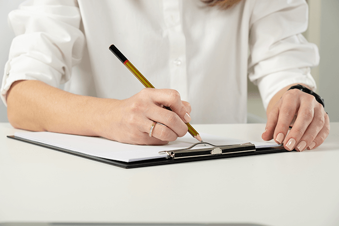 A woman filing out patent forms for an open MRI